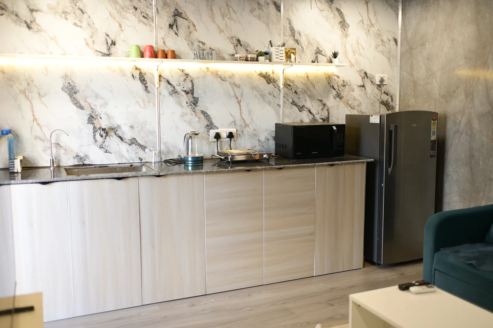 Fitted kitchen with marble-look panelling inside a CabinWala container home