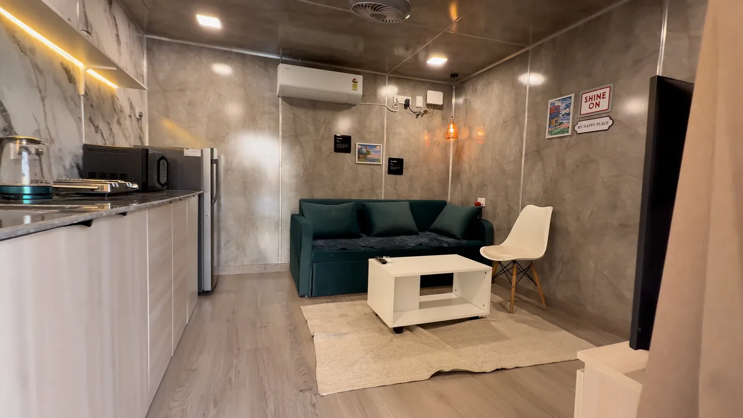 Modern living area with kitchenette inside the container Airbnb — CabinWala